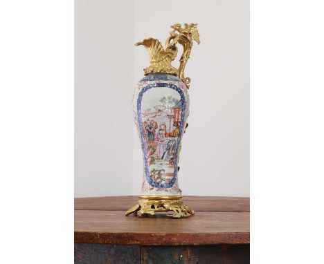 A famille rose export porcelain ewer,18th century, Chinese, of baluster shape painted with panels of figures within blue bord