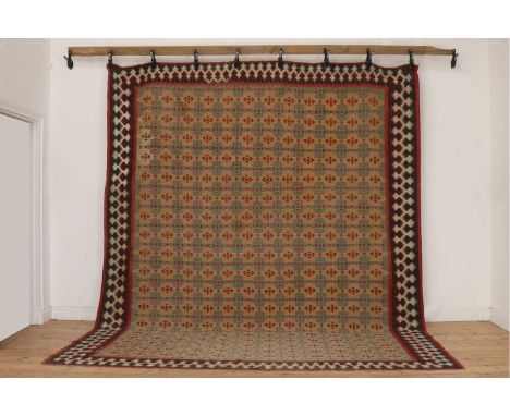 A Senneh kilim wool carpet,20th century, the pale blue and field decorated with geometric motifs, within a similarly detailed