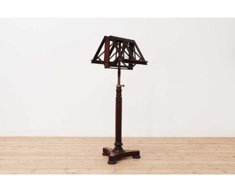 A William IV duet music stand,early to mid 19th century, with an adjustable reeded column support on a triform base,43cm wide