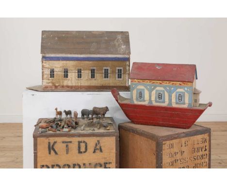 A painted wooden Noah's Ark, 19th century, decorated in red, blue and cream with a sliding panel to the reverse,63cm wide18cm