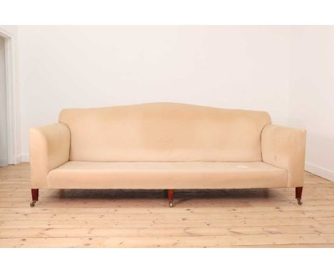 A large country house sofa in the manner of Howard & Sons,late 20th century, with a camel back, deep seat, and raised on tape