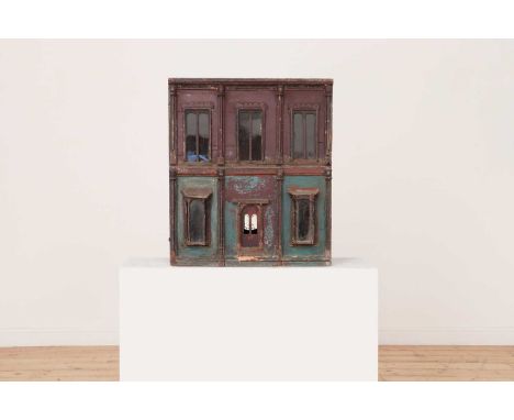 A painted double front doll's house,19th century, with bay windows, finished in layers of brown and blue paint, opening front