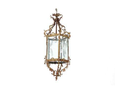 A large gilt-brass-framed hall lantern,early 20th century, of five sides, with star-cut glass panels, to an acanthus leaf and