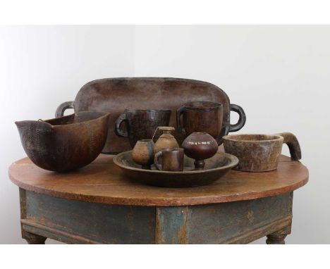 A carved wooden platter,20th century, Zulu, with a dish carved top with a handle to either end and raised on short legs, 71cm