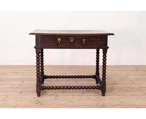 A James II oak side table,the moulded rectangular top above a single drawer, raised on bobbin-turned stretchered supports, te