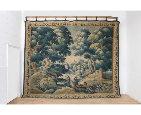 A Flemish Oudenaarde verdure tapestry,late 17th century, worked with a watermill, flora and fauna,300 x 380cmProvenance: Mr &