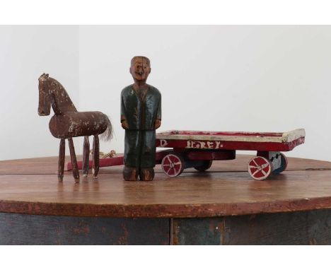 A folk art carved wooden model of a horse, dray and drayman,late 19th century, of rustic construction, the dray inscribed 'D.