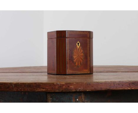 A George III yew wood octagonal tea caddy,early 19th century, the top and front inlaid with paterae, within crossbanded and s