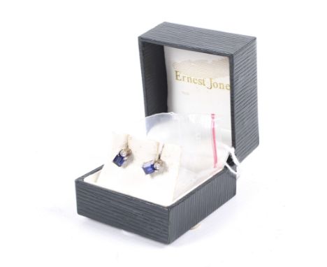 A pair of vintage 9ct gold, rectangular synthetic-sapphire and tiny diamond stud earrings. The posts with indistinct hallmark