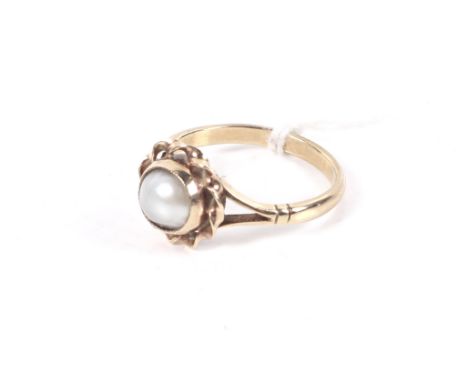 A vintage 9ct gold and cultured-half-pearl single stone ring. The 7.5mm round half-pearl rub-over set within an open spiral-t