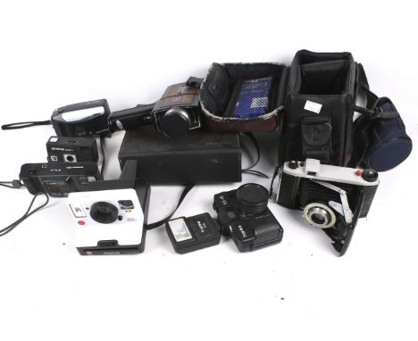 An assortment of vintage film cameras. Including a cine camera, etc. 