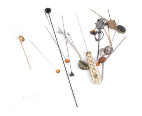 A collection of hat and stick pins. Including a French gold and cultured pearl shell shaped stick pin, 1.3g; and many other e