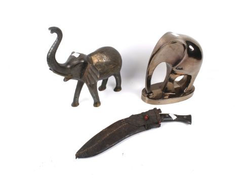 Two contemporary elephant figures and a Nepalese kukri. One of the figures constructed of brass with etched details, the othe