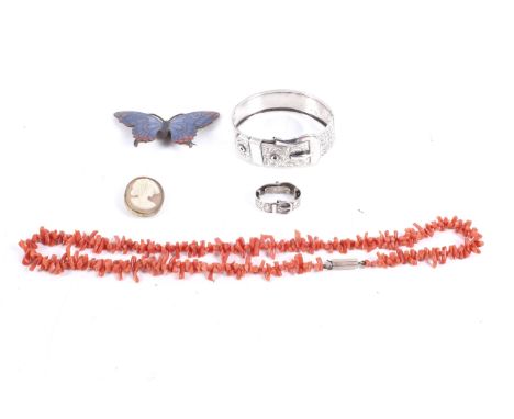 A small collection of jewellery. Comprising a silver 'Buckle' bangle, hallmarks for Chester 1939; a branch-coral necklace; an