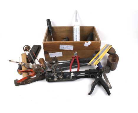A box of assorted hand tools. Including a wet stone, etc. 