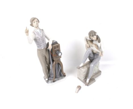 Two Nao figures. One modelled as a photographer, the other of a woman playing a guitar, Max. H32cm