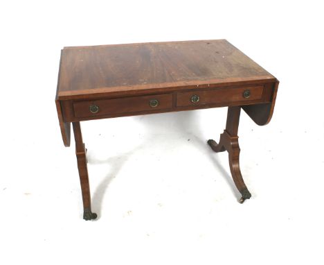 A Victorian vennered sofa table. With two short drawers, raised on swept supports terminating in brass paw casters, H73cm x W