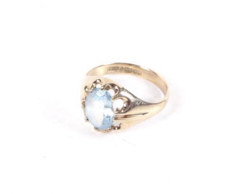 A vintage 9ct gold and oval aquamarine single stone gypsy-type ring. The oval mixed-cut pale aquamarine claw set between tape