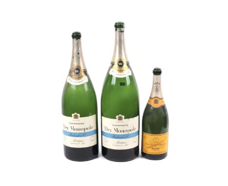 Three large empty bottles of vintage champagne. One dated 1953, the other two 1961