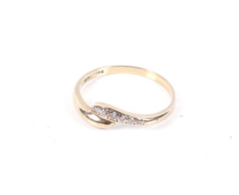 A vintage 9ct gold and cubic zirconia cross-over ring. The six round stones claw set on a shallow D-section shank with hallma