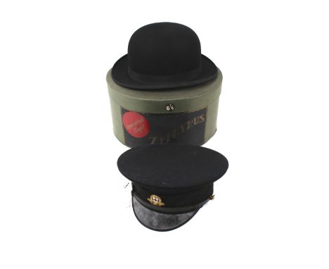 Two gents hats. Comprising a vintage Moores Zephyrus bowler hat, size 6 7/8, with a box and a British Red Cross peak cap. 