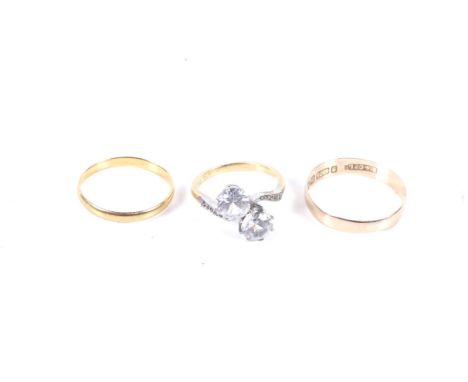 Three gold rings. Comprising a 22ct gold wedding band, hallmarks for Birmingham 1950, 1.4g; an Edwardian 9ct gold wedding ban