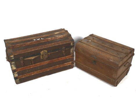Two vintage dome topped travel trunks. Comprising a cast metal example, H43.5cm x W66.5cm x D45.5cm, the other with metal bra