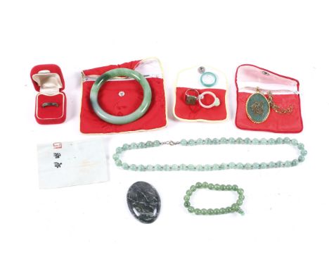 A collection of Chinese imitation-jade jewellery. Including a green glass slave bangle; bead necklaces and a ring