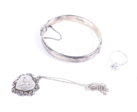 A vintage silver part-foliate engraved hinged bangle and other items. The bangle with hallmarks for Birmingham 1967, 16g; tog