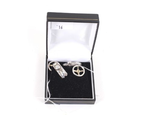 A pair of vintage silver cufflinks. Each in the form of a classic E-Type Jaguar car and a steering wheel, with chain interlin