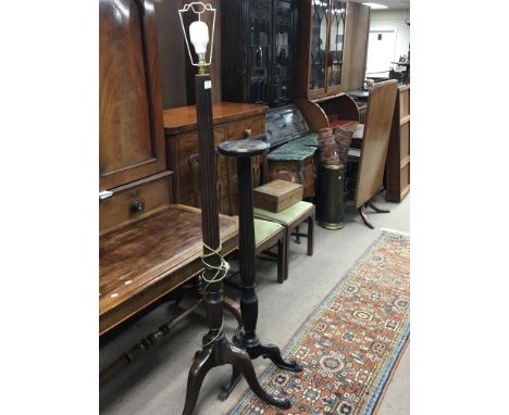 A Mahogany standard lamp with a flutted column and a mahogany plant stand (2)