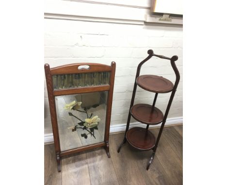 A folding cake stand and painted glass fire screen