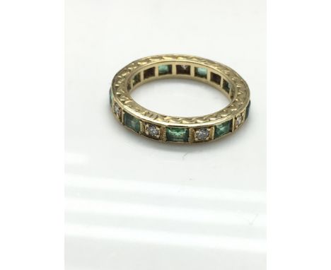 A diamond and emerald full eternity ring. Weight approx 4.92g, size approx K.