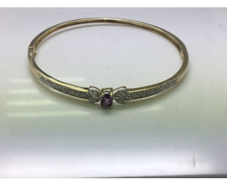 A 9ct diamond and amethyst bangle. Weight approx 7.34g