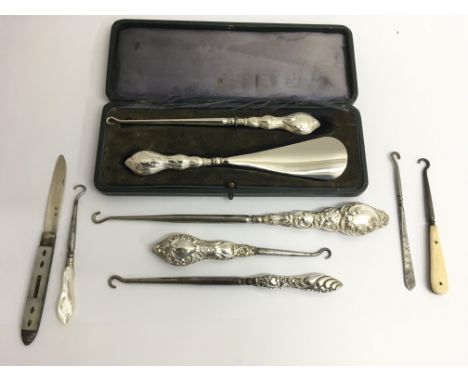 Two silver button boot hook set, one cased, a Georgian silver penknife and other hooks