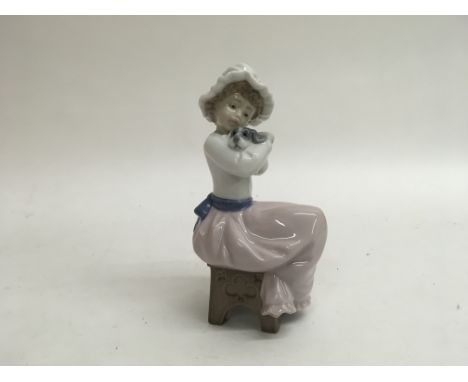 A Nao figure of a young girl hugging a small dog titled “a big hug” it’s original box. Standing approximately 18cm tall.
