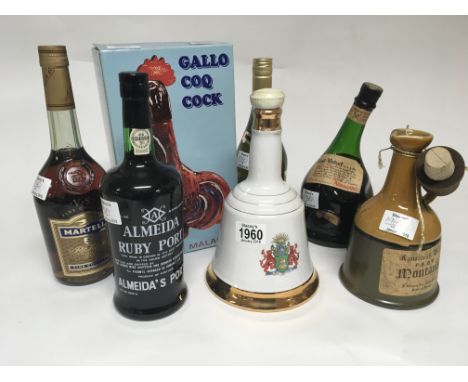 A collection of Cognac Whisky and others comprising a bottle of Saint-Vivant Armagnac Martel and Napoleon Brandy a bottle of 