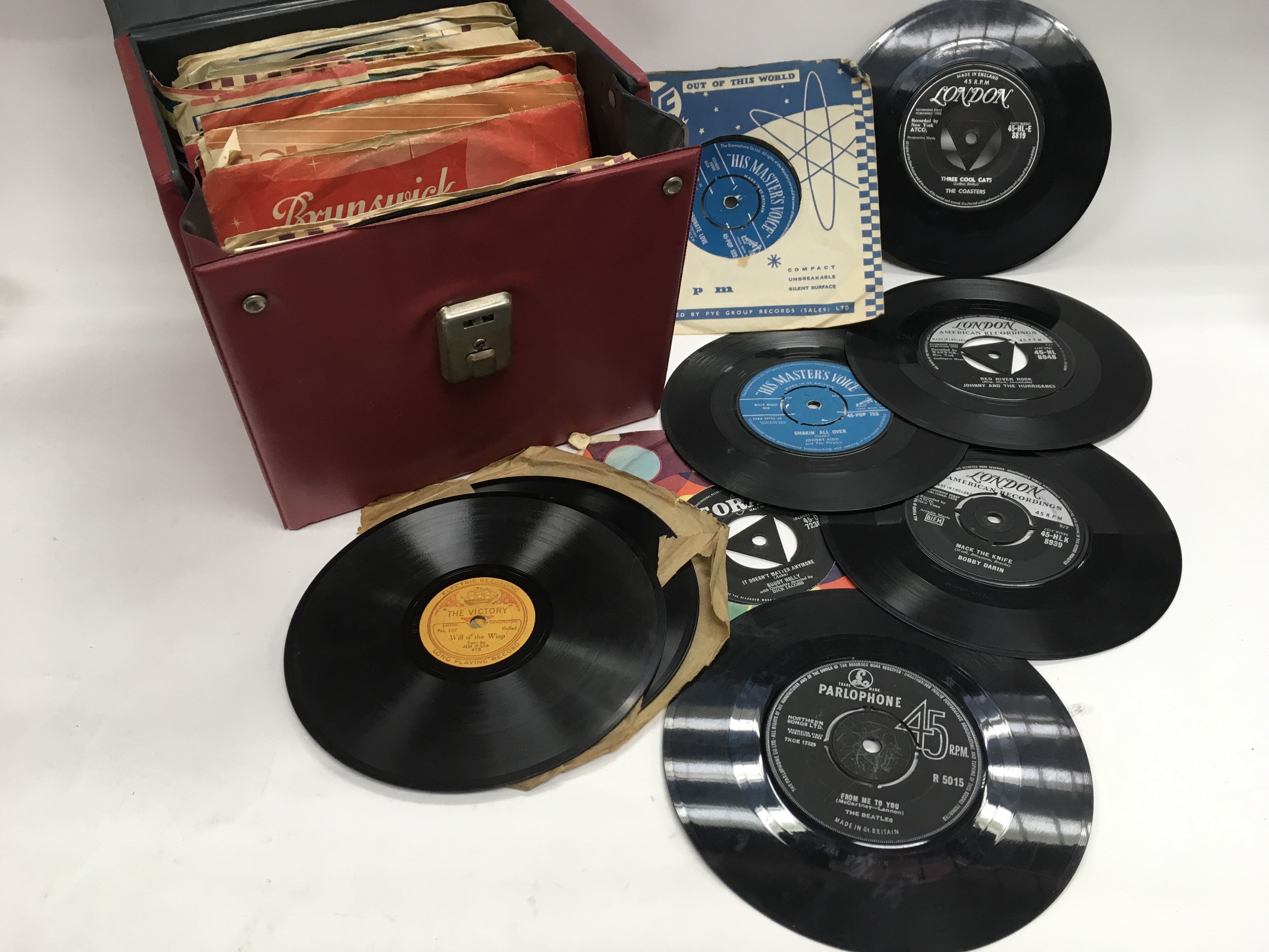 A portable HMV record player and various 10inch and 7inch vinyl records ...