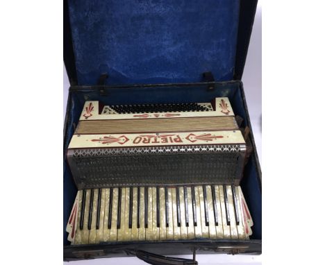 A cased Pietro piano accordion.