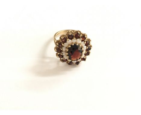 A large 9ct gold oval garnet and opal cluster ring.