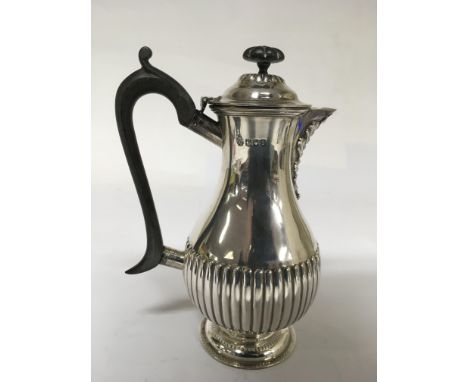 A silver coffee pot with gadrooned base, London hallmarks for William Hutton and Sons.Approx 20cm high, 429g