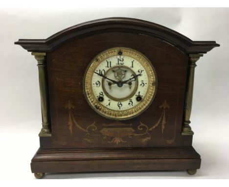 An Edwardian inlaid mahogany mantel clock.