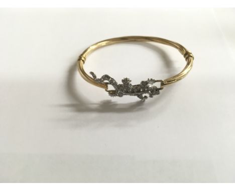 A 9ct gold stone set lizard bangle.