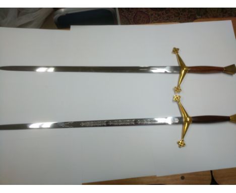 Two modern swords with mahogany grips, one bearing the marks of Wilkinson sword in dedication to Queen Elizabeth II