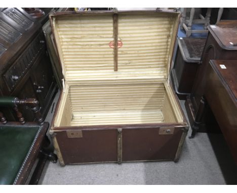 A large canvas trunk with interior striped liner.