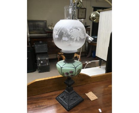 An oil lamp with a green coloured glass reservoir. Height approx 63cm.