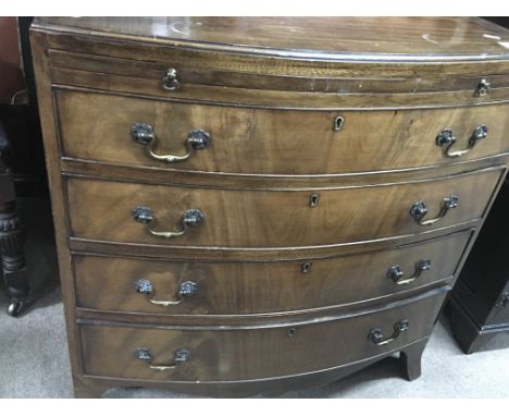 A Small Mahogany bow fronted chest of drawers with a brushing slide and four graduating drawers on bracket feet. Size 75x 46c