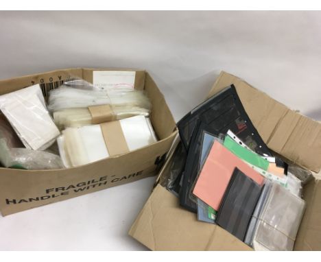 Fourteen mixed stamp stock books all empty and two boxes of mostly new cellophane envelopes etc for post cards or advertising