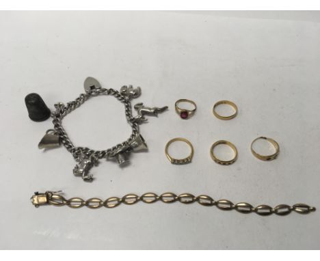 A silver charm bracelet (weight approx 47.1g) a 9ct gold bracelet (weight approx 8.9g) and five gold rings (some 22ct, weight