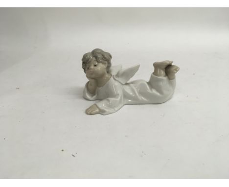 A Lladro figure of a young boy as an angel titled “Angel laying down” with the original box and a Lladro information leaflet.